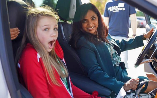 Abigail Raisanen (left) from Stevenson Middle School in Westland. Michigan got a charge out of hearing FCA Chief Information Officer Mamatha Chamarthi rev the engine during the GET-IT Girls field trip at FCA.