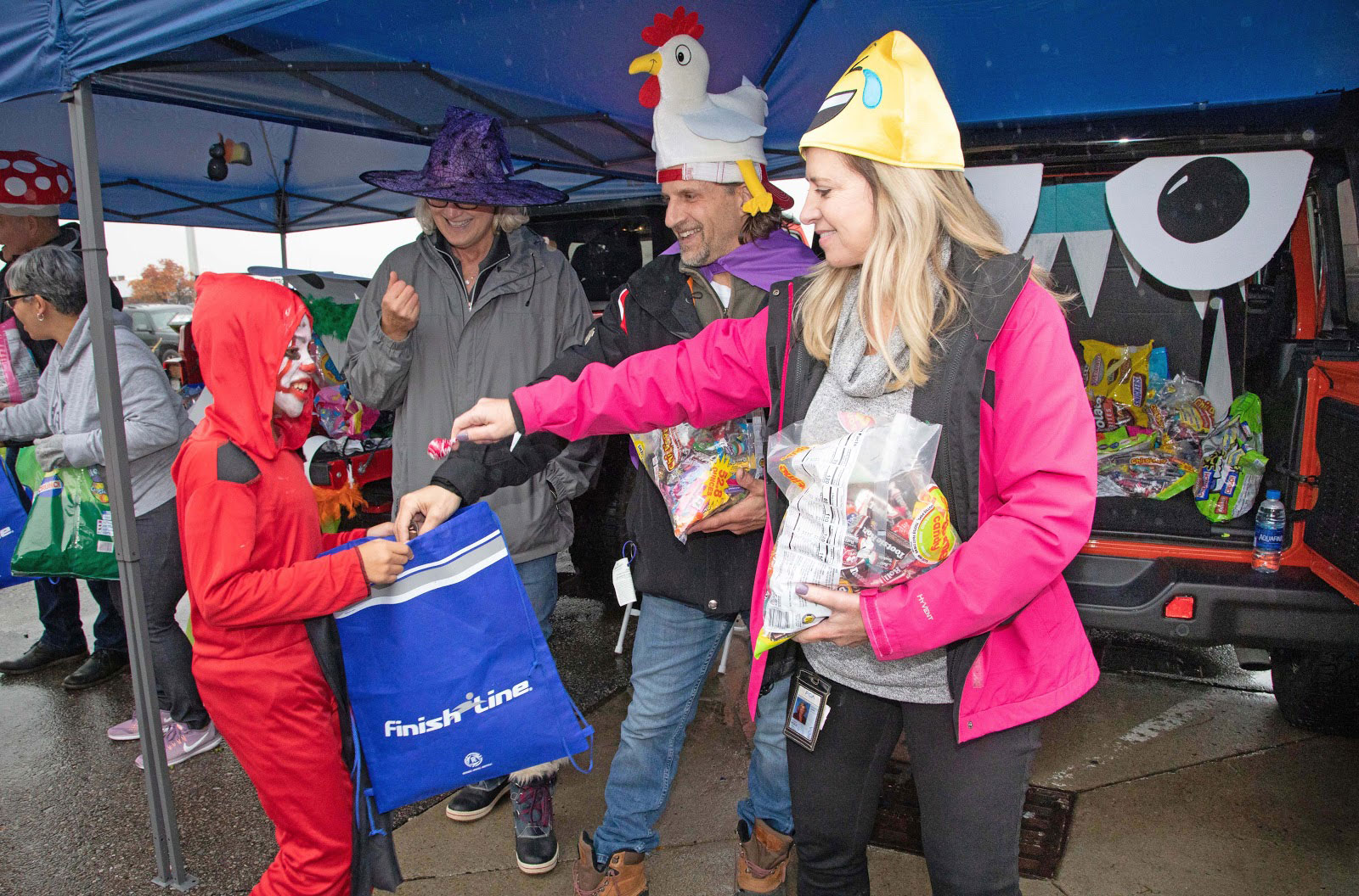 Denise Debouvre (left), Manager–HR Communications Lead, and Laurie Vitale (right), Head of Internal Audit and Compliance, FCA–North America, help hand out candy to the kids.