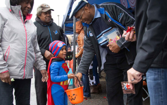 Will Tolbert, Manager–Paint Shop Center-Jefferson North Assembly Plant, hands out candy to a youngster.